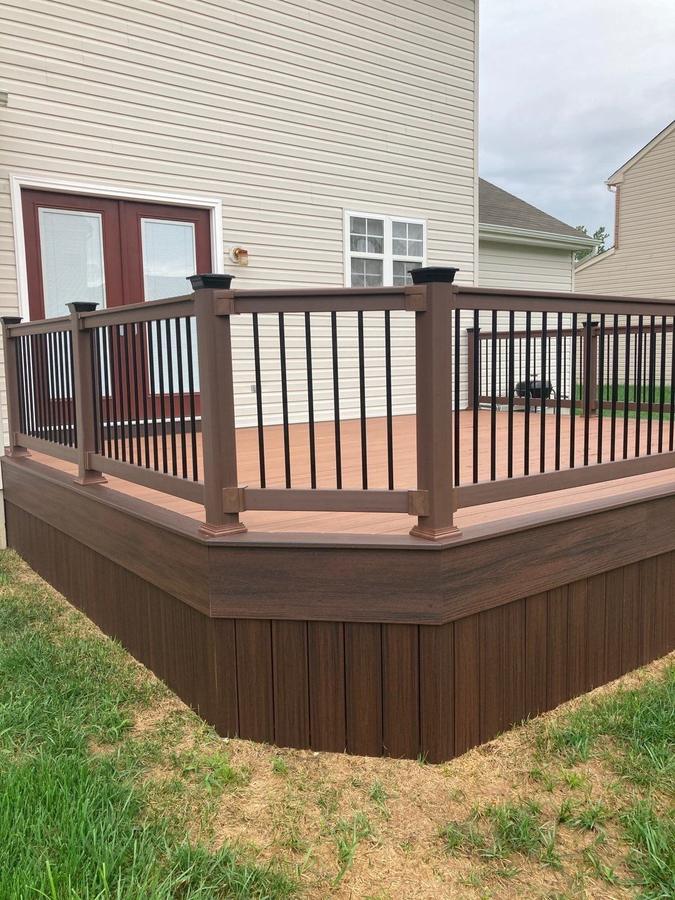 Two-tone composite deck with dark railing and post caps