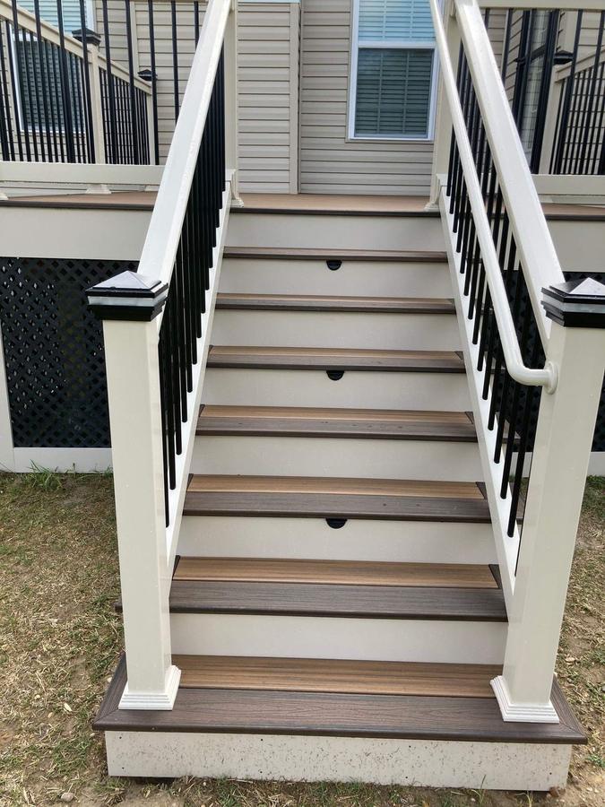 Exterior staircase with composite treads and black balusters