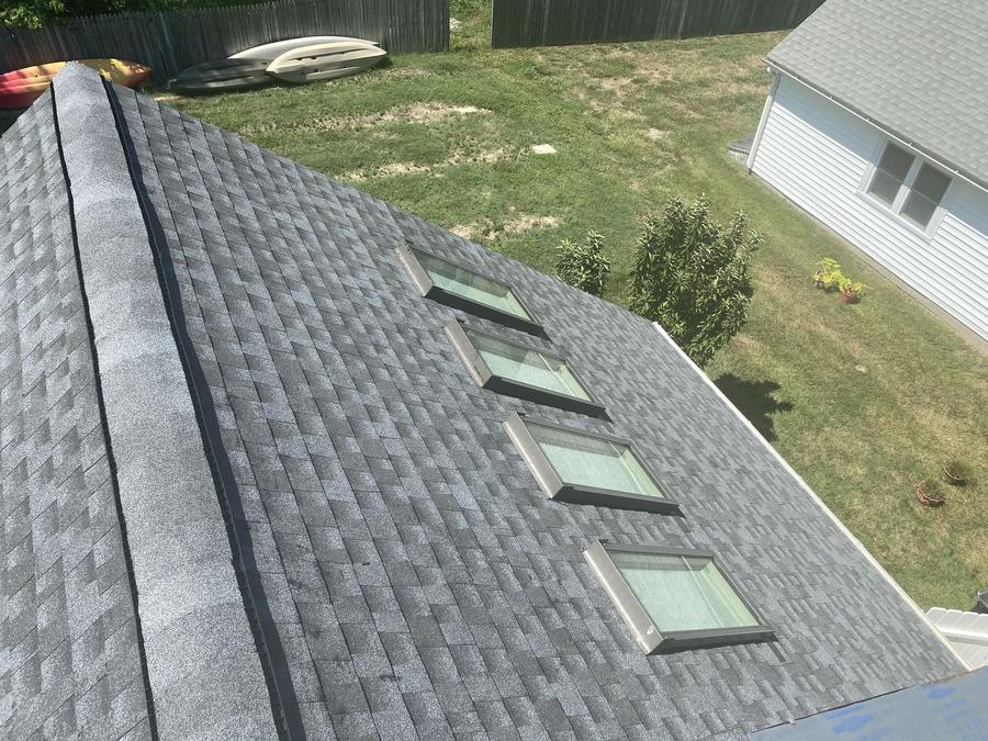 New architectural shingle roof with a row of four skylights