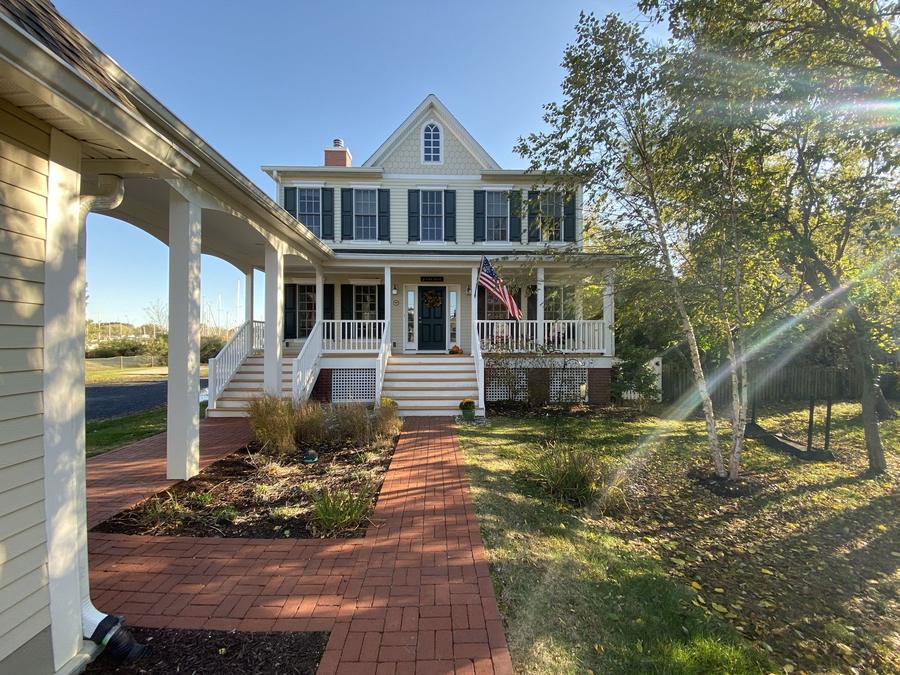 Two-story home with a covered front porch and white railing