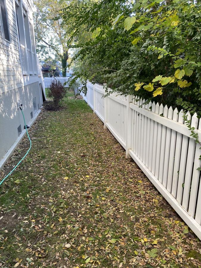 White picket fence running along a waterfront property line